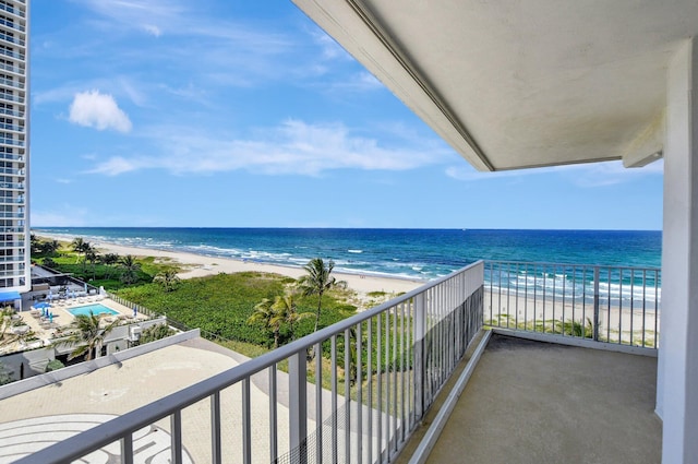 balcony featuring a water view and a view of the beach