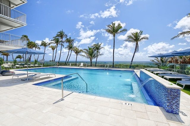 view of swimming pool with a patio and pool water feature