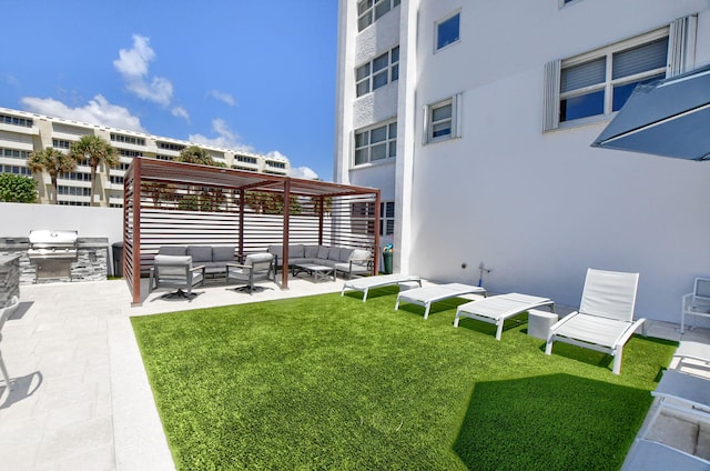 view of yard featuring a pergola, an outdoor kitchen, and outdoor lounge area