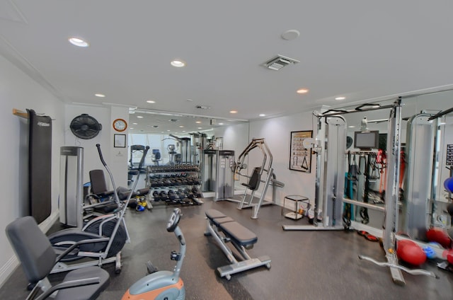 workout area featuring ornamental molding