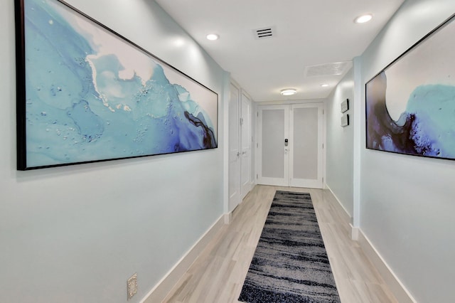 hall with light hardwood / wood-style flooring