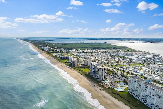 birds eye view of property featuring a beach view and a water view