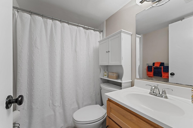 bathroom with toilet, vanity, and a shower with curtain