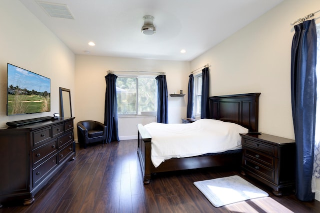 bedroom with dark hardwood / wood-style floors