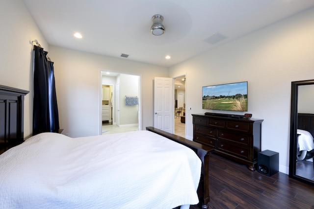 bedroom with dark hardwood / wood-style floors and ensuite bath