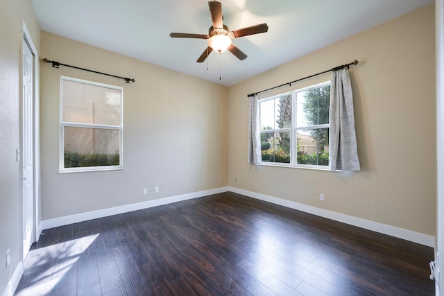 empty room featuring dark hardwood / wood-style flooring and ceiling fan