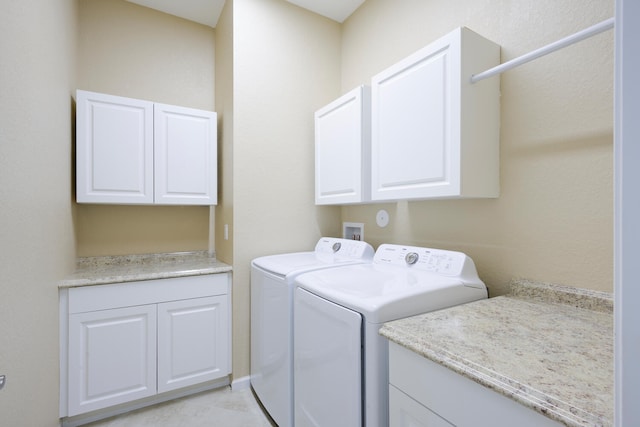 laundry room featuring washer and dryer, cabinets, hookup for a washing machine, and light tile floors