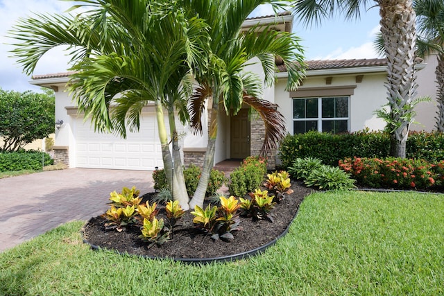 view of front of house with a front yard and a garage