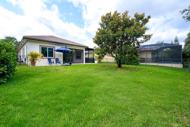 view of yard featuring a lanai and a patio