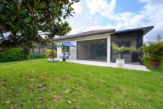 back of property featuring a yard and a patio area