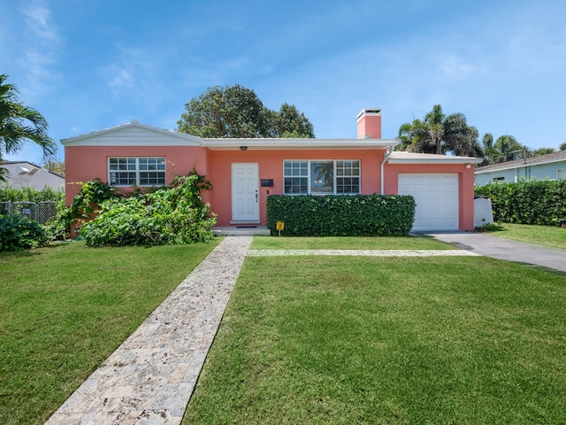 ranch-style home featuring a garage and a front lawn