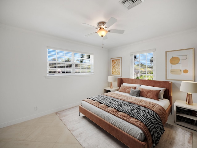 bedroom with ceiling fan, crown molding, and light tile floors