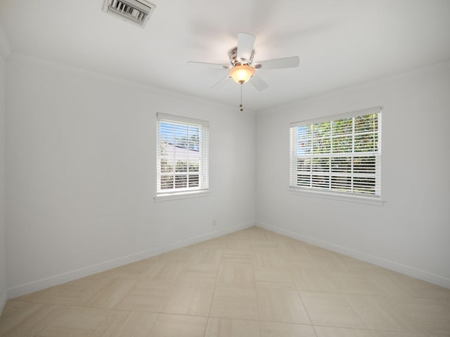 spare room featuring crown molding, ceiling fan, and light tile floors