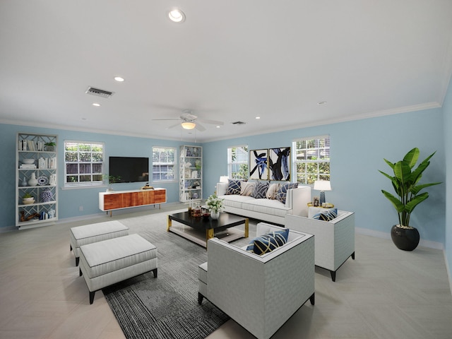 living room featuring a wealth of natural light, ceiling fan, and ornamental molding