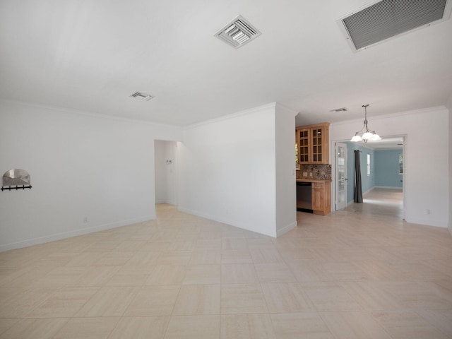 tiled spare room with crown molding and an inviting chandelier