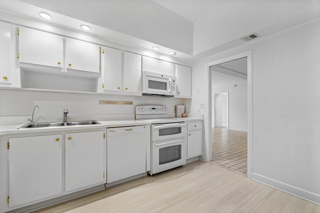 kitchen with white cabinetry, sink, white appliances, and light hardwood / wood-style flooring