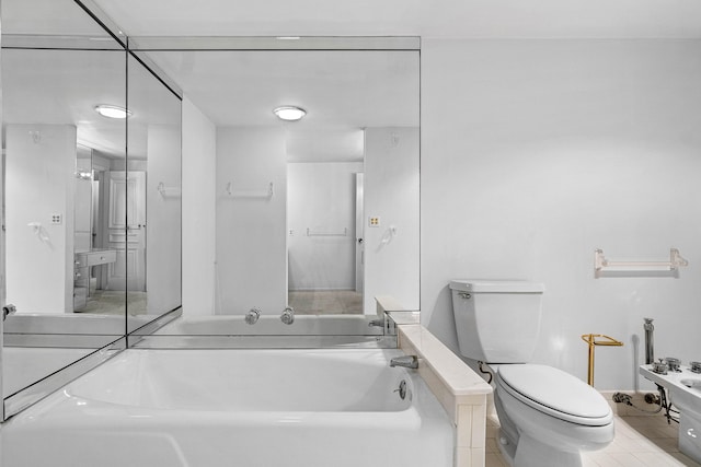 bathroom with toilet and a bath