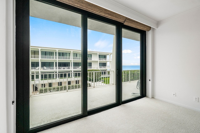 doorway featuring carpet floors, ornamental molding, and a water view