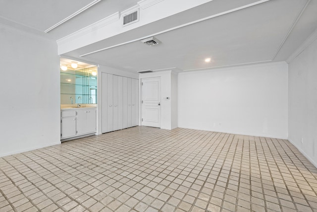 interior space with ornamental molding and sink