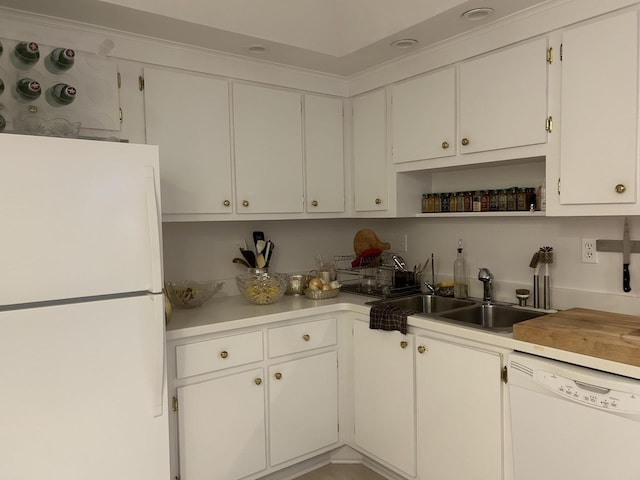 kitchen featuring white cabinetry, white appliances, and sink