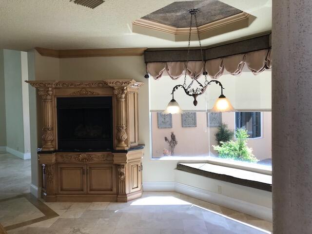 bathroom featuring a raised ceiling, crown molding, and tile flooring