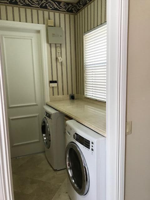 laundry room with tile flooring and washer and dryer