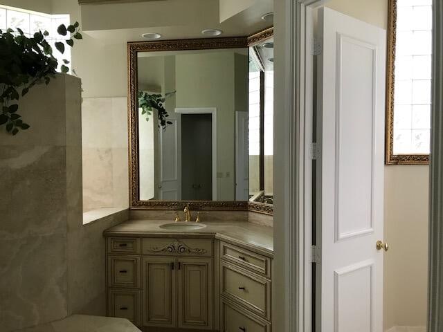 bathroom featuring oversized vanity and tile walls