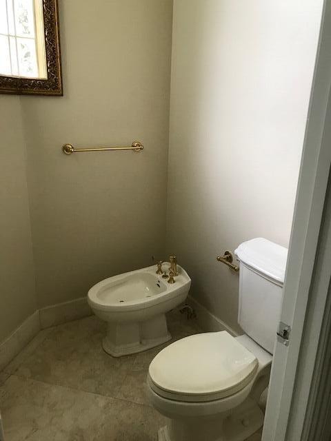 bathroom featuring tile floors, a bidet, and toilet