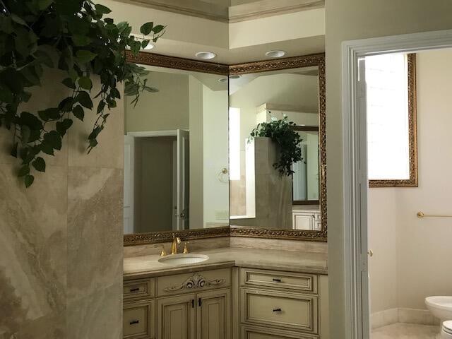 bathroom featuring oversized vanity and toilet