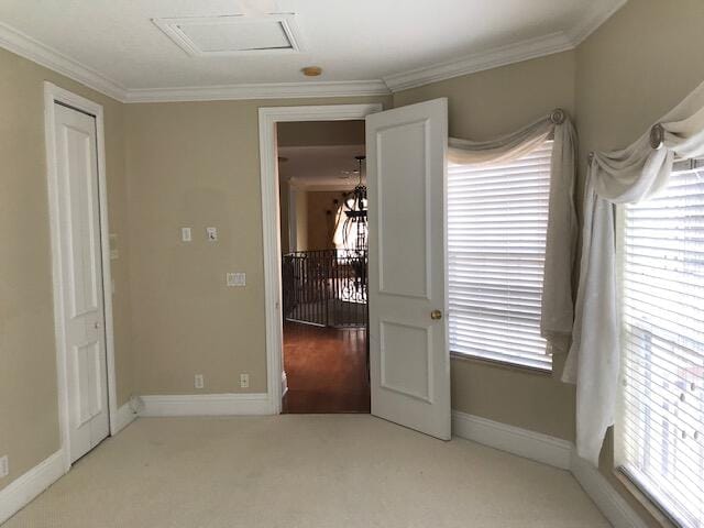 carpeted bedroom featuring multiple windows, crown molding, and an inviting chandelier