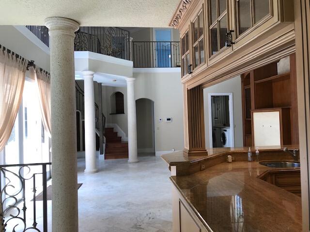 interior space featuring washer / clothes dryer, sink, decorative columns, and a textured ceiling