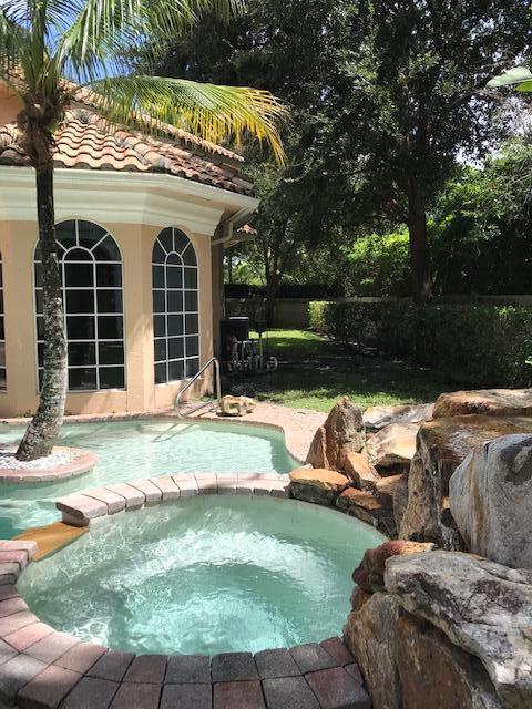 view of swimming pool with an in ground hot tub