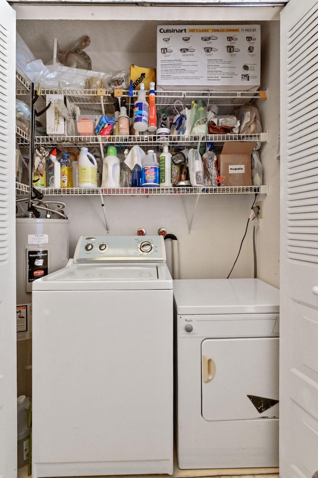 washroom featuring electric water heater and separate washer and dryer