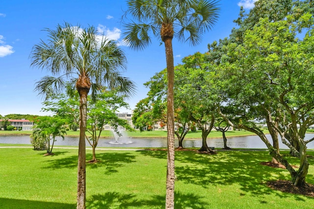 surrounding community featuring a lawn and a water view