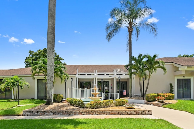 view of front of house featuring a pergola and stucco siding