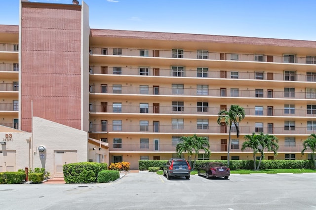 view of building exterior with uncovered parking