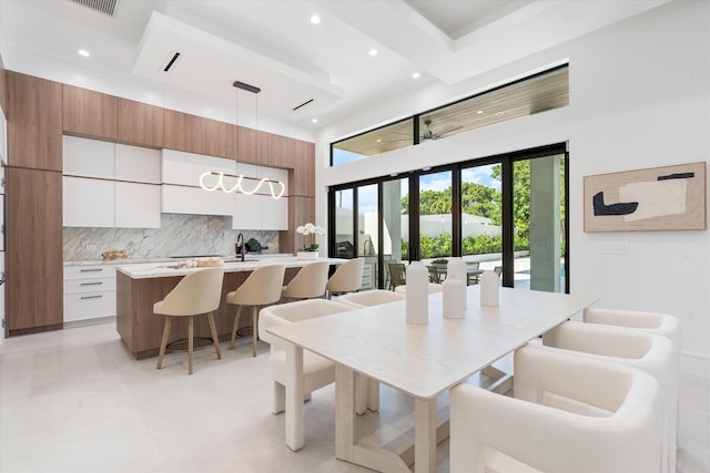 dining space with french doors and a high ceiling