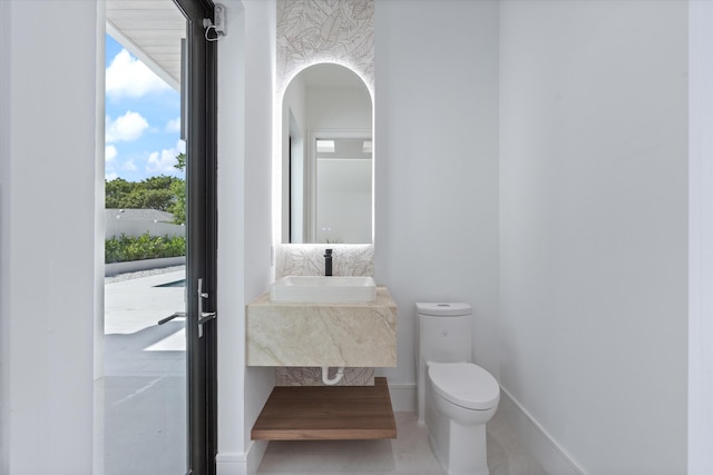 bathroom featuring toilet and sink