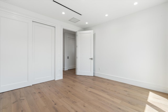 unfurnished bedroom with light wood-type flooring