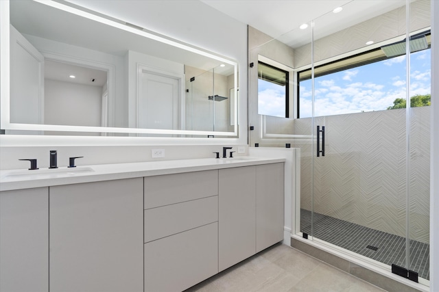 bathroom with vanity and a shower with door