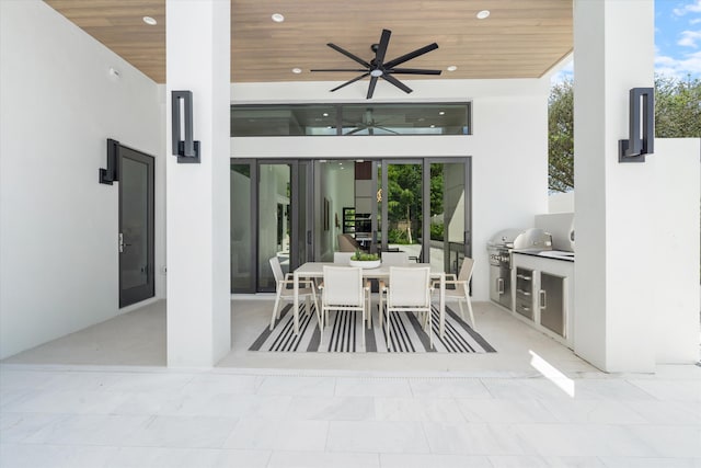 view of patio featuring grilling area, ceiling fan, and exterior kitchen