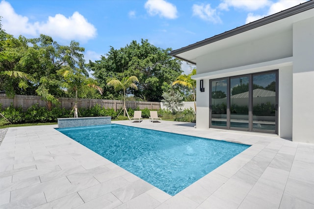 view of pool with a patio area and pool water feature