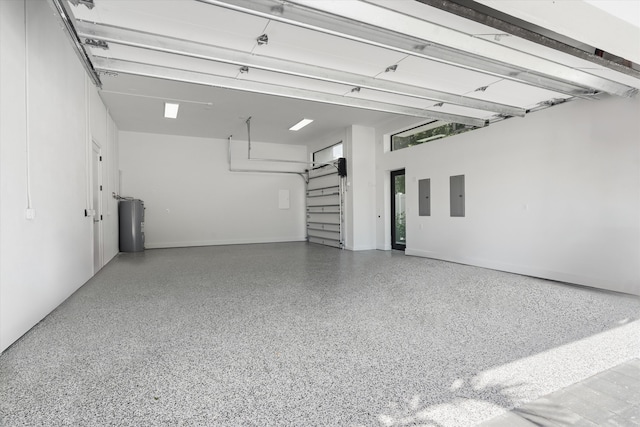 garage featuring electric panel and water heater