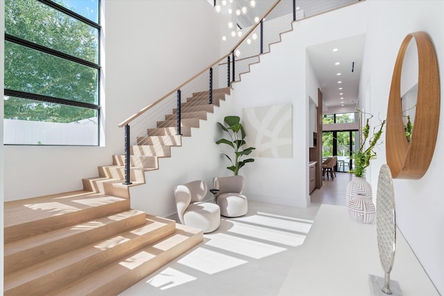 staircase featuring a towering ceiling