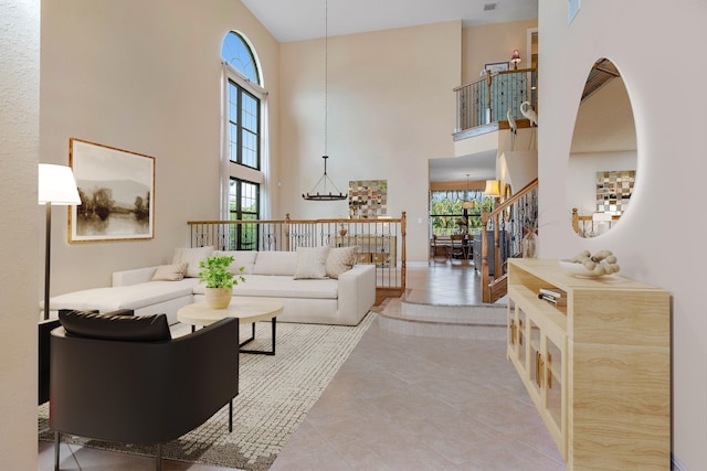 living room featuring light tile patterned flooring, a towering ceiling, and a notable chandelier