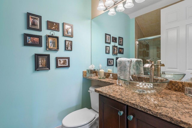 bathroom with vanity, toilet, and walk in shower