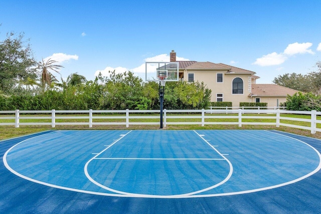 view of basketball court featuring a lawn