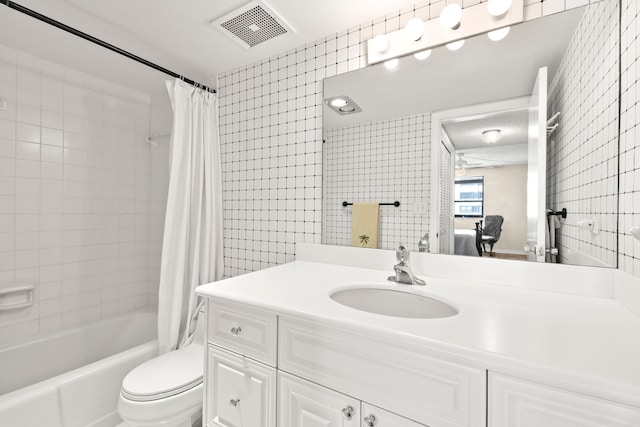 full bathroom with ceiling fan, large vanity, shower / bath combo, and toilet