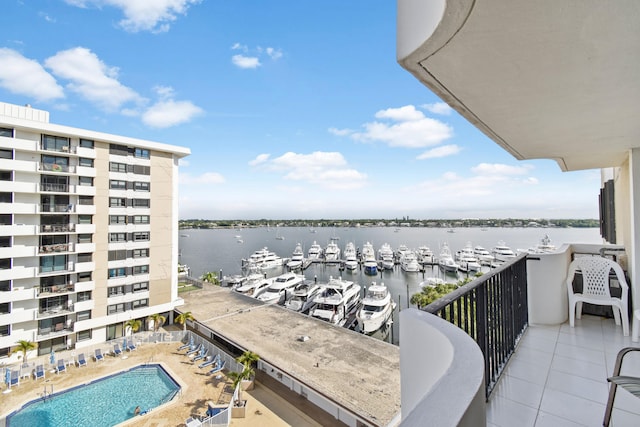 balcony featuring a water view and a community pool