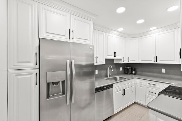 kitchen featuring sink, appliances with stainless steel finishes, and white cabinetry